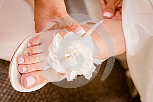 Beautiful Bridal Wedding shoe design. Adorned with a touch of white flower design at the top. photo