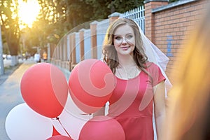 Beautiful bride with balloons in the park