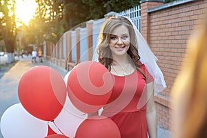 Beautiful bride with balloons in the park