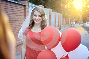 Beautiful bride with balloons in the park