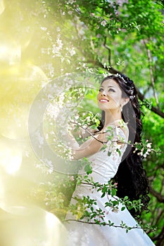 Beautiful bride in a blossoming garden