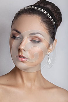 Beautiful bride with fashion wedding hairstyle - on white background.Closeup portrait of young gorgeous bride. Wedding.