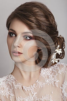 Beautiful bride with fashion wedding hairstyle - on white background.