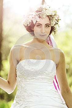 Beautiful bride with flower tiara at the tree