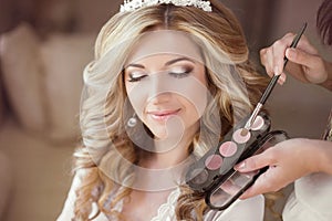 Beautiful bride girl with wedding makeup and hairstyle. Stylist