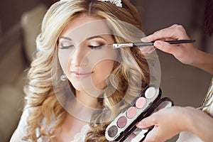 Beautiful bride girl with wedding makeup and hairstyle. Stylist