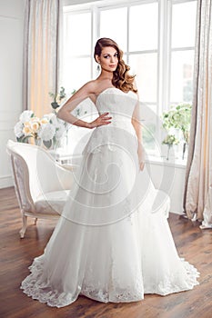 Beautiful bride in gorgeous wedding dress indoors. Wedding fashion