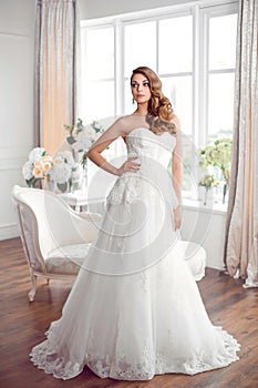 Beautiful bride in gorgeous wedding dress indoors. Wedding fashion