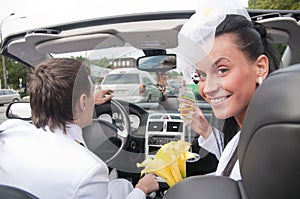 Beautiful bride and groom in cabrio photo