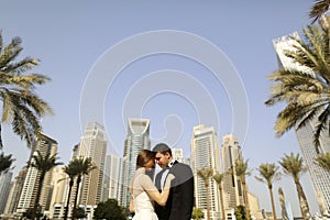 Beautiful bride and groom embracing in Dubai