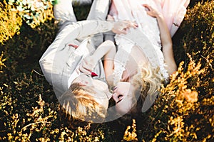 Beautiful bride and groom embracing and kissing on their wedding day outdoors