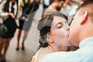 Beautiful bride and groom hugging and kissing on their wedding day outdoors. Concept wedding, new family.