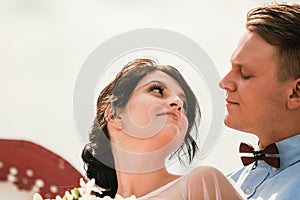 Beautiful bride and groom hugging and kissing on their wedding day outdoors. Concept wedding, new family.