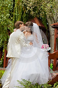 Beautiful bride and groom kissing