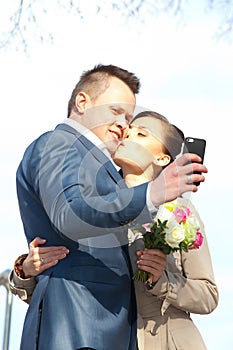 Beautiful bride and groom make selfie