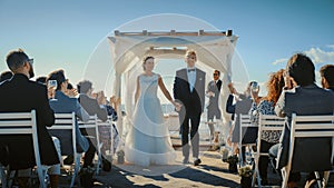 Beautiful Bride and Groom During an Outdoors Wedding Ceremony on an Ocean Beach. Perfect Venue for