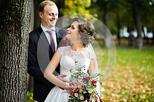 Beautiful bride and groom in the park on a sunny day