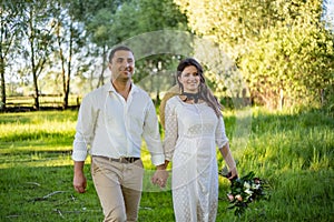 Beautiful bride and groom with sparklers on a meadow.