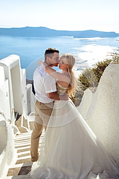 Beautiful bride and groom in their summer wedding day on greek island Santorini