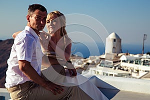 Beautiful bride and groom in their summer wedding day on greek island Santorini
