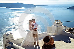 Beautiful bride and groom in their summer wedding day on greek island Santorini