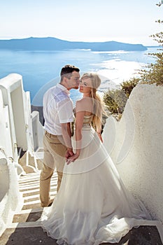 Beautiful bride and groom in their summer wedding day on greek island Santorini