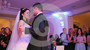 Beautiful bride and handsome groom dancing first dance at the wedding party