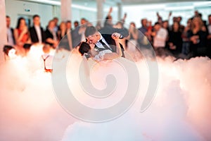 Beautiful bride and handsome groom dancing first dance at the wedding party.