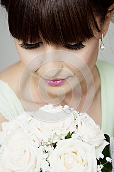 Beautiful bride with her bouquet closeup photo