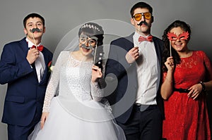 Beautiful bride with her girlfriends posing at studio