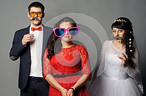 Beautiful bride with her girlfriends posing at studio