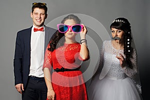 Beautiful bride with her girlfriends posing at studio