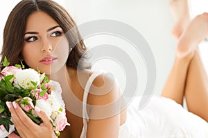 Beautiful bride holding nuptial bouquet