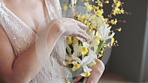 Beautiful bride is holding a wedding colorful bouquet