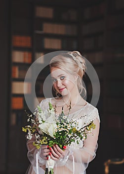 Beautiful bride indoors with bouquet