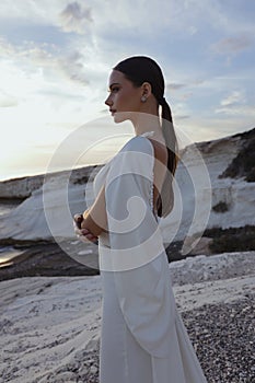 beautiful bride in luxurious wedding dress posing on the beach in Cyprus