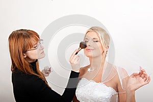 Beautiful bride and make-up artist