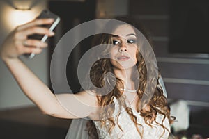 Beautiful bride making selfie in the home before wedding photo
