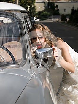 Beautiful bride near the car