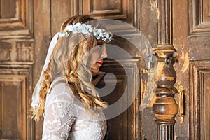 Beautiful bride portrait on old wooden door background