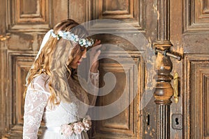 Beautiful bride portrait on old wooden door background