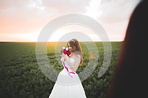 Beautiful bride posing on her wedding day in park