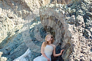 Beautiful bride posing in high mountain scenery