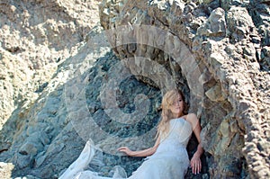 Beautiful bride posing in high mountain scenery