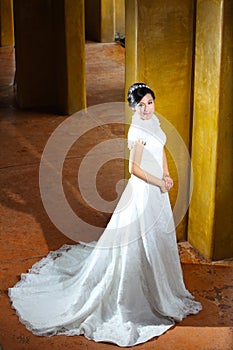 Beautiful bride posing near pillars