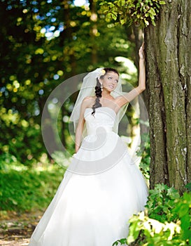 Beautiful bride posing outdoor in her wedding day