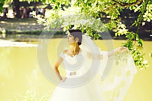 Beautiful bride on river bank