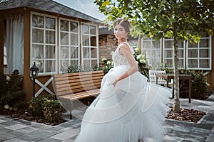 Beautiful bride running away in the garden