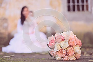 Beautiful bride's bouquet behind the blurred bride