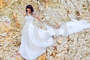 Beautiful bride among sands thoughtful